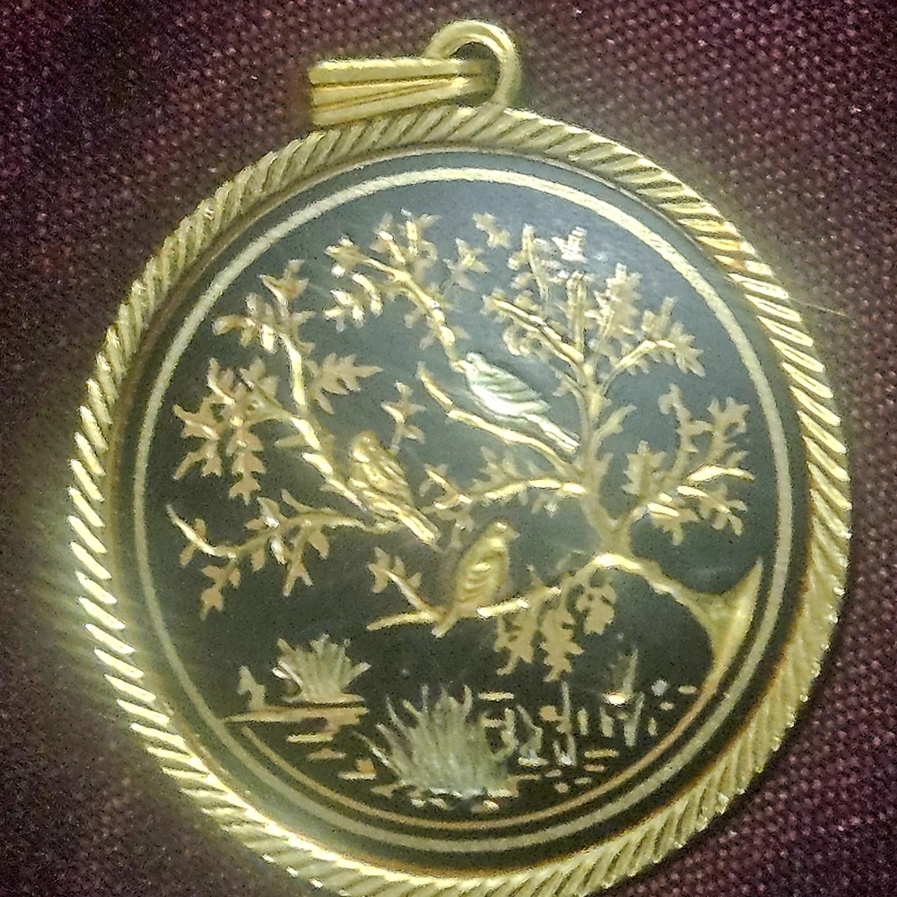 Elegant Gold and Black Bird Pendant